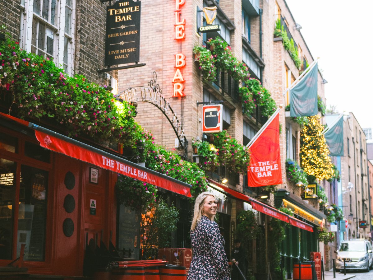 A Dublin pub front hung with flowers and lit signs