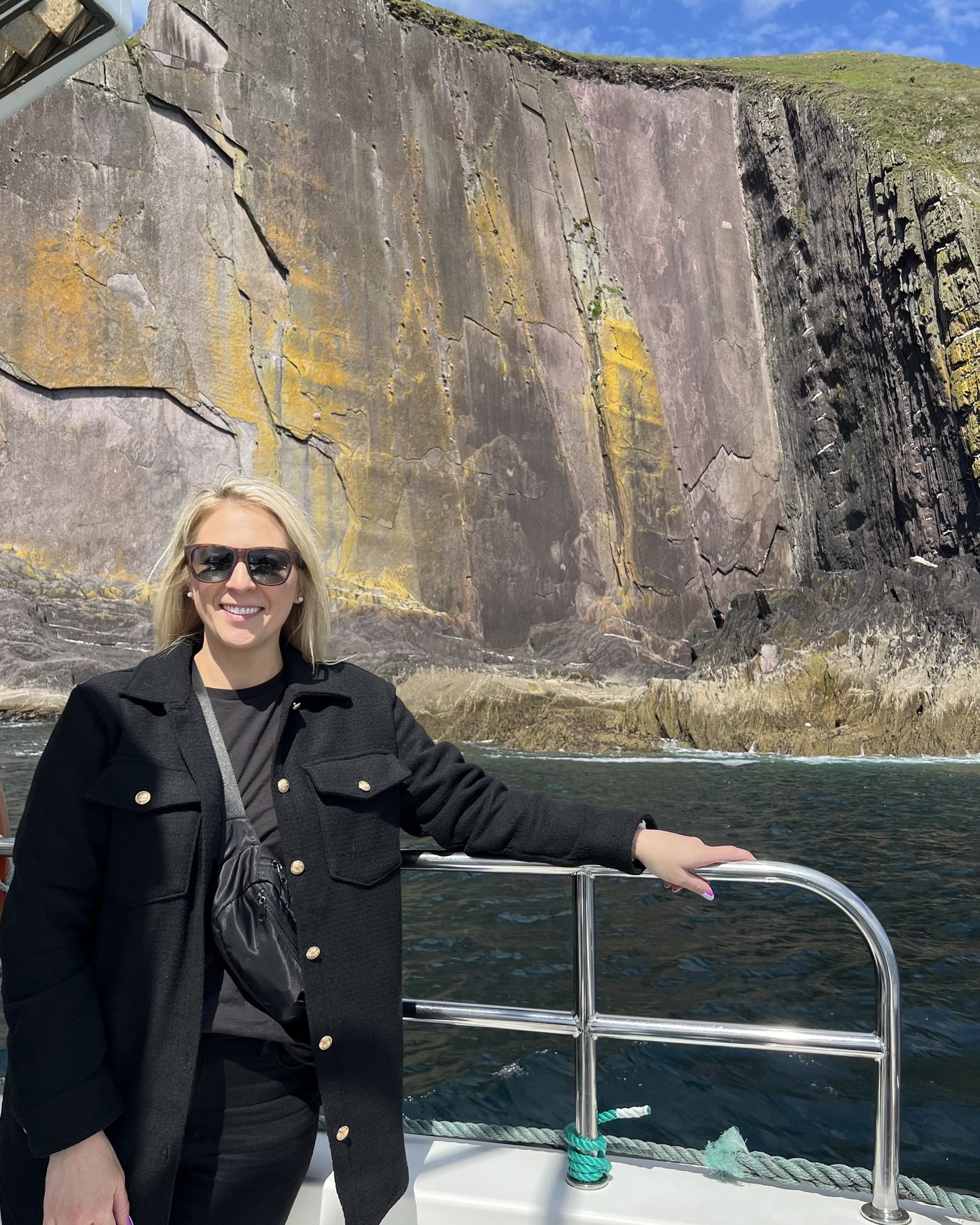 Jenny on the water below sea cliffs in Ireland