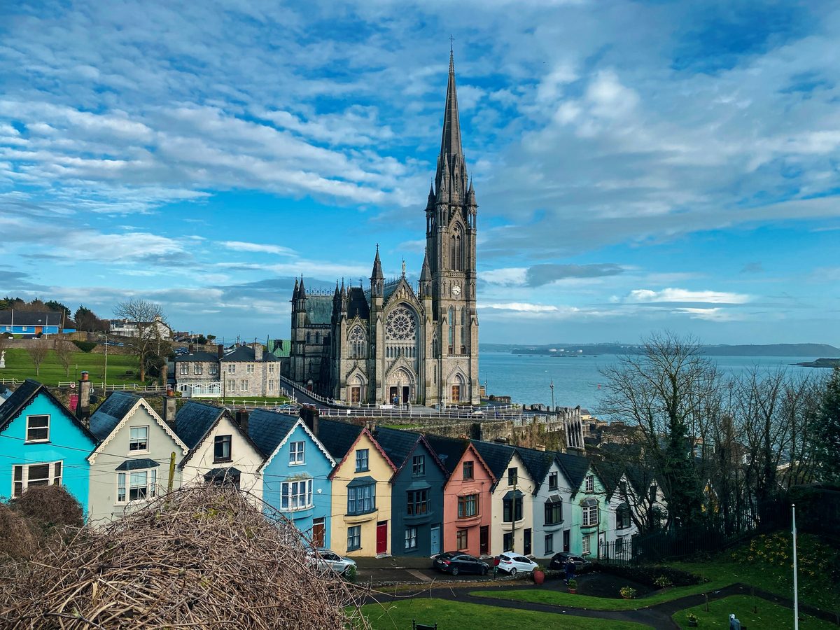 Bright houses and the cathedral above Cobh harbor